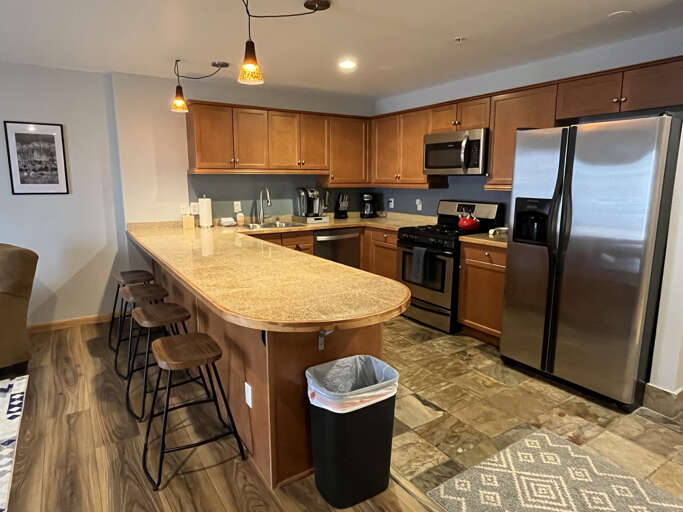 Your fully equipped kitchen features stainless steel appliances, granite countertops, and a breakfast barâperfect for preparing home-cooked meals and gathering with loved ones.