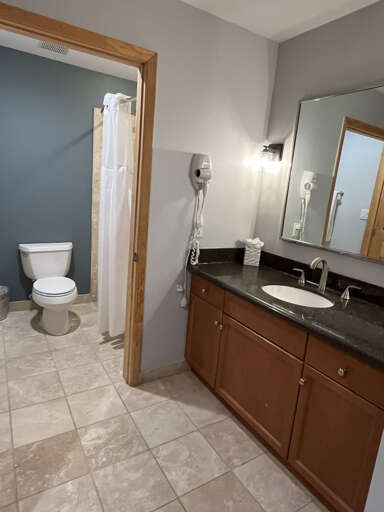 Your private bathroom offers everything you need to refresh, with a shower tub combo granite countertops, and thoughtful touches like fluffy towels and a handy hair dryer.