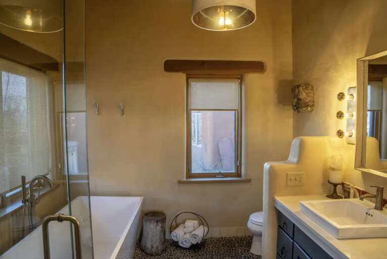 Step into your serene bathroom sanctuary, where a luxurious soaking tub awaits beneath warm lighting. Spa-inspired touches and thoughtful design create your perfect retreat after exploring the area.