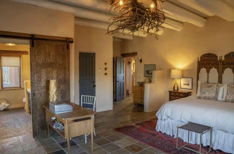 Step into your spacious retreat where rustic charm meets refined comfort. Vaulted ceilings, handcrafted details, and warm lighting create an inviting atmosphere. Your plush king bed awaits, promising restful nights after days of exploration.