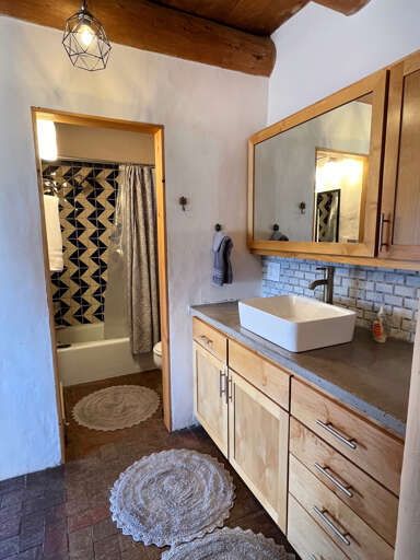Full bathroom with vanity and storage