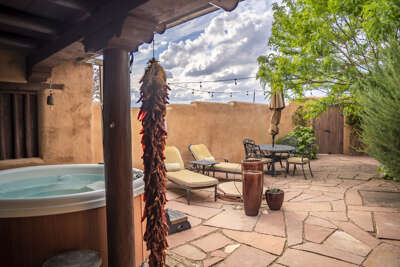 Soak in your private hot tub under the Southwestern sky, surrounded by adobe walls and lush greeneryâa serene retreat for complete relaxation.