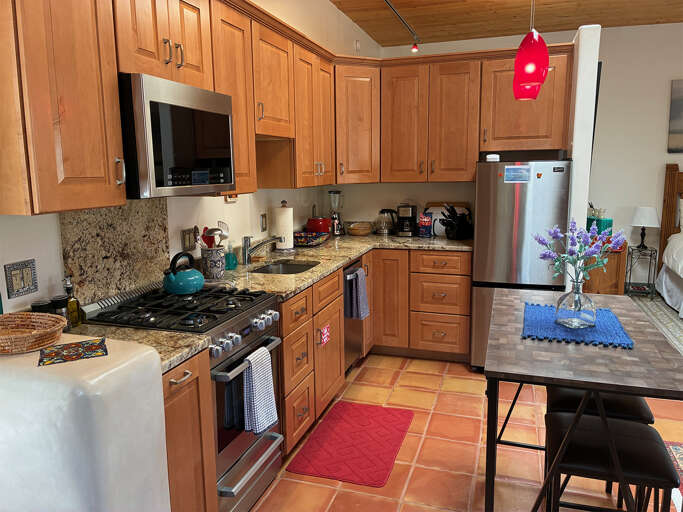 Your fully-equipped kitchen awaits with granite counters, stainless appliances, and everything you need to whip up a favorite meal. Warm wood cabinetry and colorful accents make cooking feel like home.