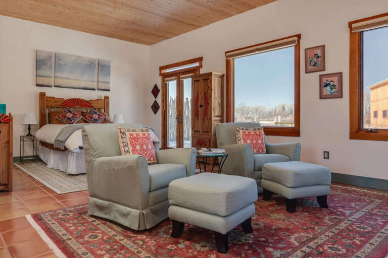 Sink into plush seating while natural light pours through wood-framed windows. Colorful textiles and southwestern touches create your own cozy retreat under warm pine ceilings.
