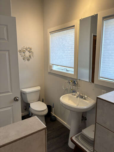 Freshen up in your private bathroom with natural light streaming through the windows, creating a bright and welcoming space to start your day.