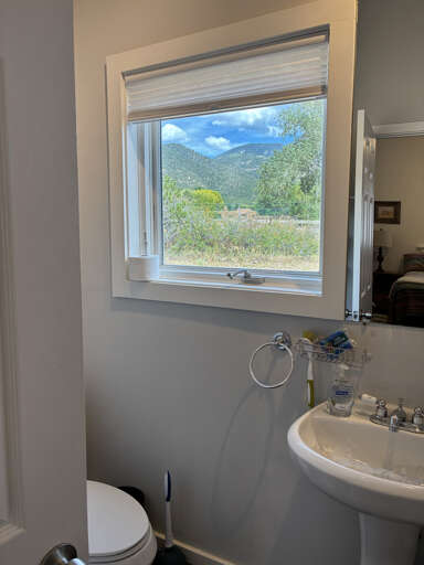 Refresh in your bright bathroom while gazing at stunning mountain scenery through the windowâa serene view that makes every moment feel like an escape.