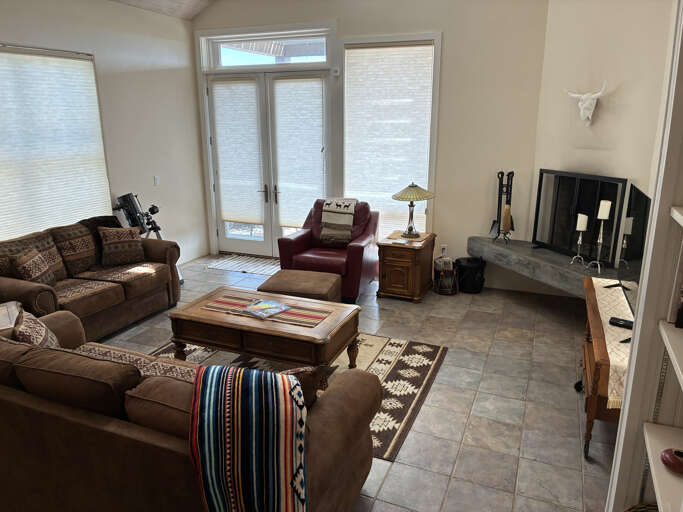 Settle into your spacious living room where natural light fills the space and comfortable seating invites you to unwind. The cozy fireplace adds warmth while you plan your next adventure or simply relax with loved ones.