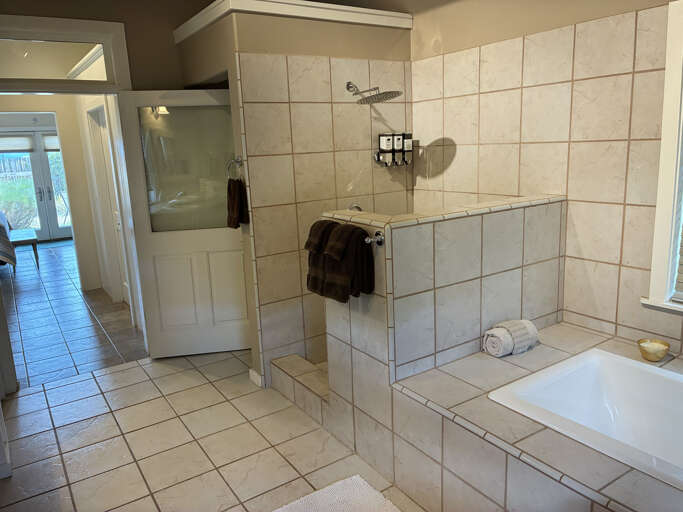 Unwind in your spacious bathroom with a tiled walk-in shower and deep soaking tubâperfect for washing away the day's adventures.