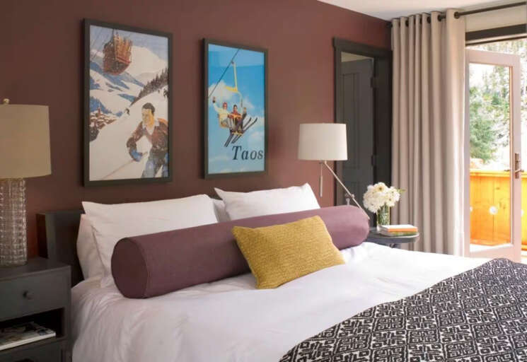 Sink into plush bedding and let the mountain-inspired decor transport you. Your private balcony awaits, framed by soft curtains and daylight.