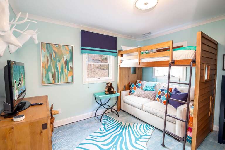 Upstairs Bunk Bedroom with Twin Top and Full-Sized Sleeper Sofa Below