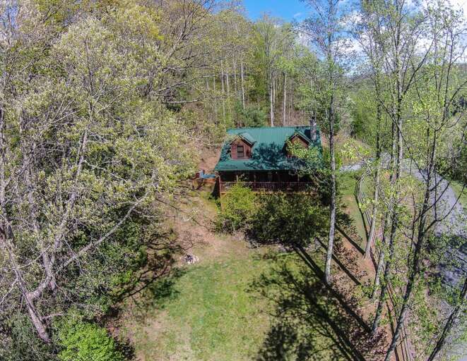 3 Bears Den Front Side of Home With Large Yard and Outdoor Fire Pit