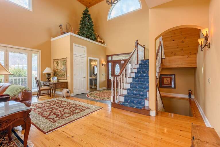Grand Front Entryway, Stairs Accessing Upper and Lower Levels of A Glowing View