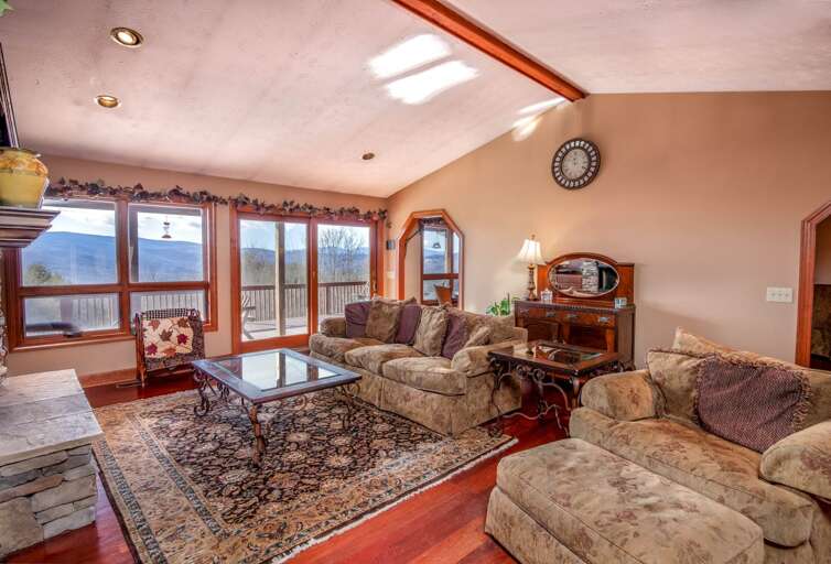 Living Room with Sweeping Views and Stone Fireplace Living Room with Sweeping Views and Stone Fireplace
