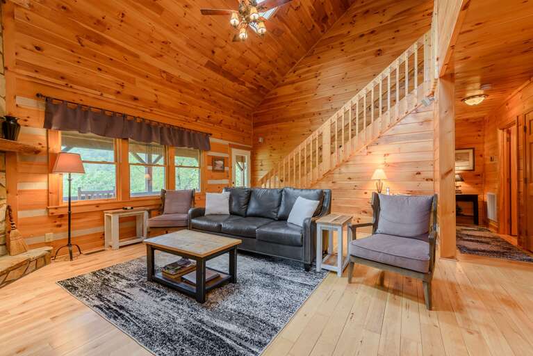 Living Room With Comfy Seating and Rustic Wood Walls Living Room With Comfy Seating and Rustic Wood Walls