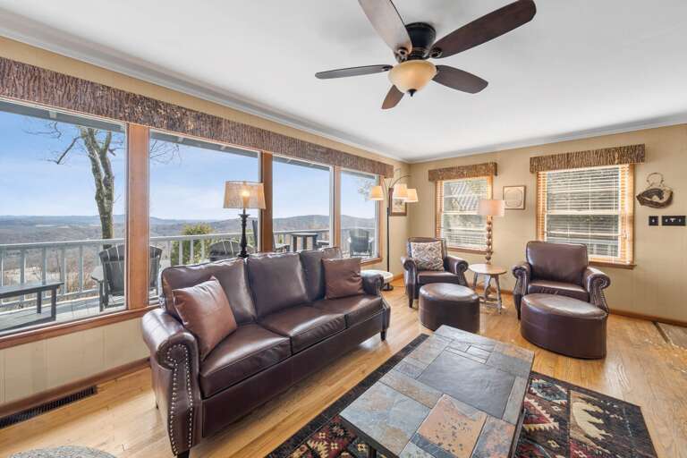 Cozy Living Room with Warm Wood Floors and Scenic Landscape Cozy Living Room with Warm Wood Floors and Scenic Landscape