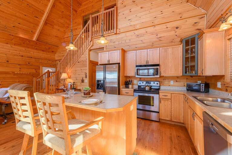 Wooden Cabin Interior With Kitchen And Dining Area