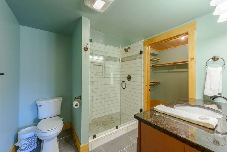 Downstairs Full Bathroom with Granite Vanity and Tile Shower