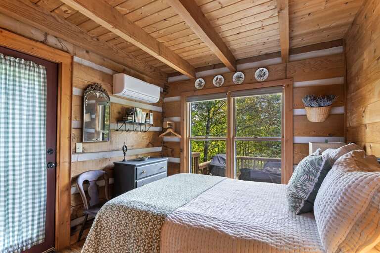 Lots of Natural Light and Tasteful Decor in the Primary Bedroom with a Mini Split for Heat and A/C Lots of Natural Light and Tasteful Decor in the Primary Bedroom with a Mini Split for Heat and A/C