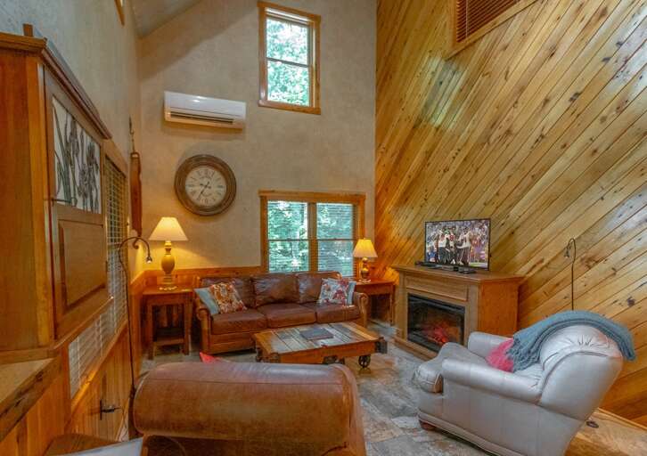 Living Room with Leather Furniture, Flatscreen TV, and Stone Fireplace