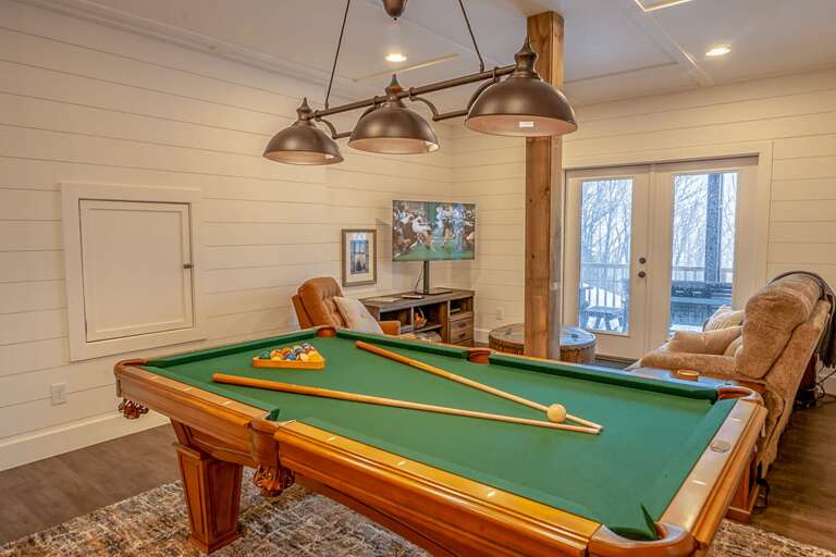 Pool table and second living area are found downstairs