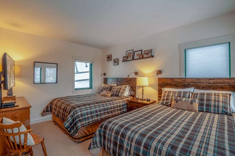 Queen bedroom with two queen beds and TV on main level