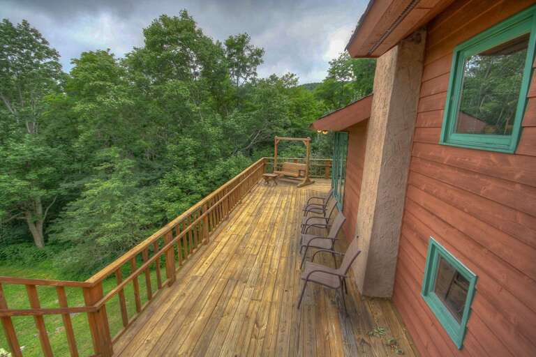 Wraparound porch with a swing and seating