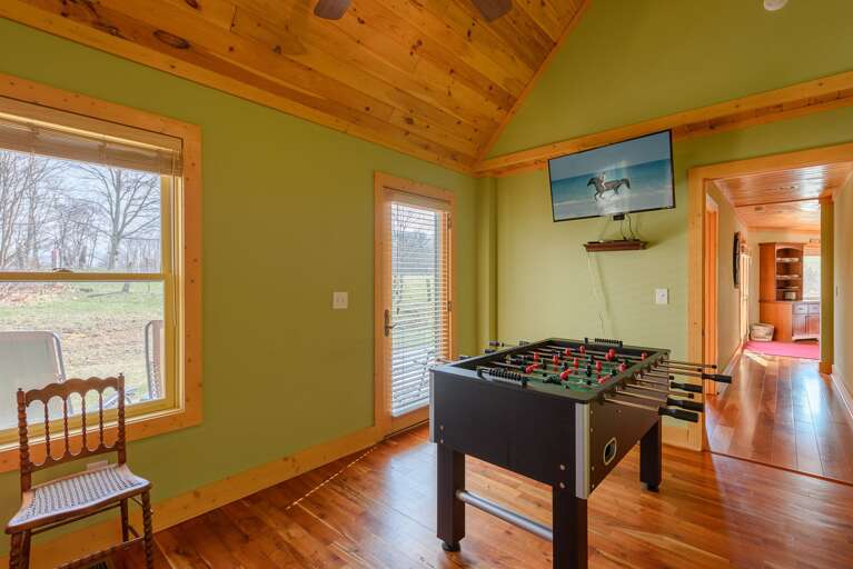 Bunk room on Main level with access to back deck, TV, foosball table Bunk room on Main level with access to back deck, TV, foosball table