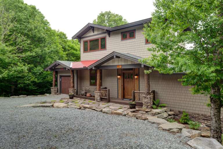 Front of Cardinal Perch with Level Gravel Parking and Custom Features