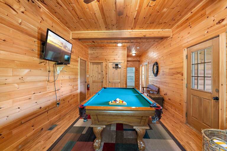 Lower Level Game Room with Pool Table, TV, and Deck Access