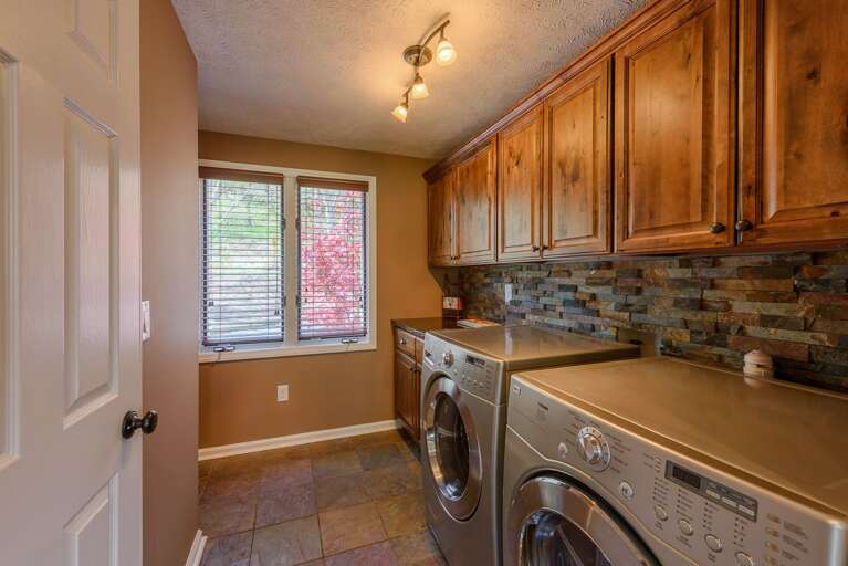 Large laundry room with utility sink, half-bath