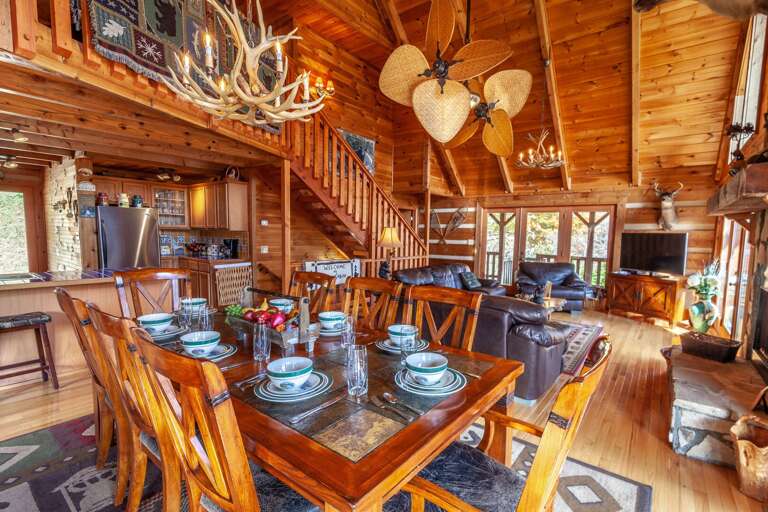 Main Level Living Area Boasts Hardwood Floors, Vaulted Ceilings, a Stone Fireplace, and Open Floor Plan