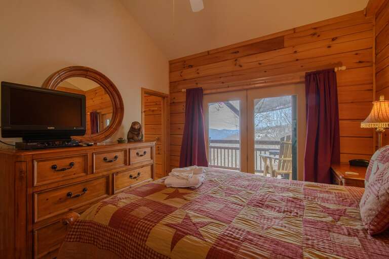 Queen Bedroom on Main Level with TV, Private Entrance to Shared Bath, and Access to Main Deck
