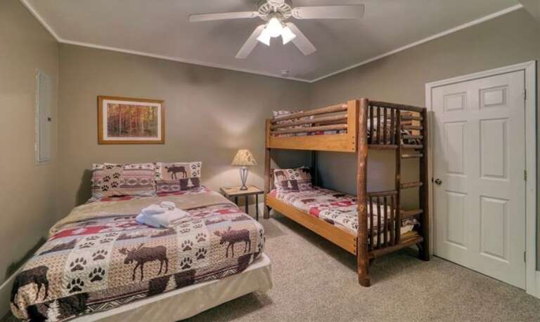 Downstairs Bedroom with Queen Bed, Twin Log Bunk Bed, HDTV and Ensuite Full Bathroom