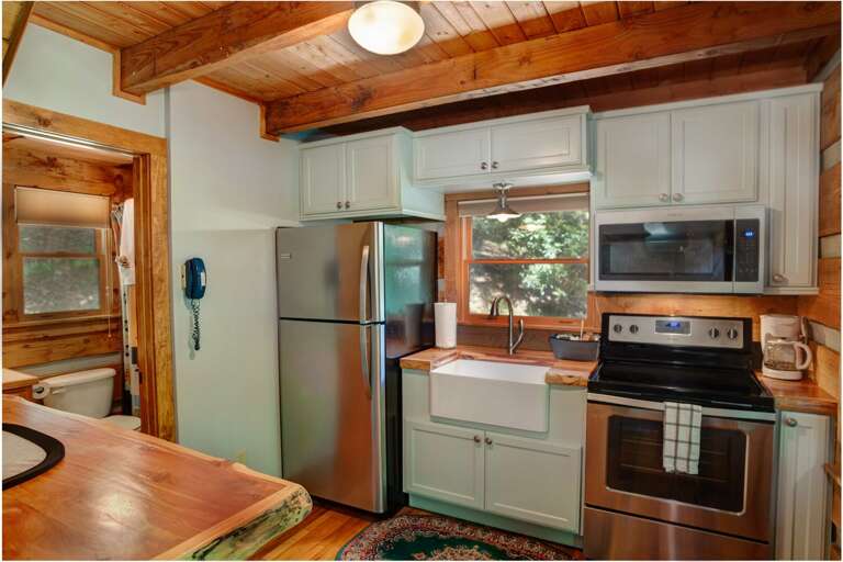 Kitchen at Little Timber Creek Cabin with Custom Live Edge Wood Countertops, Stainless Appliances