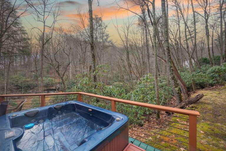 Relax in the hot tub while enjoying incredible, sweeping sunset views