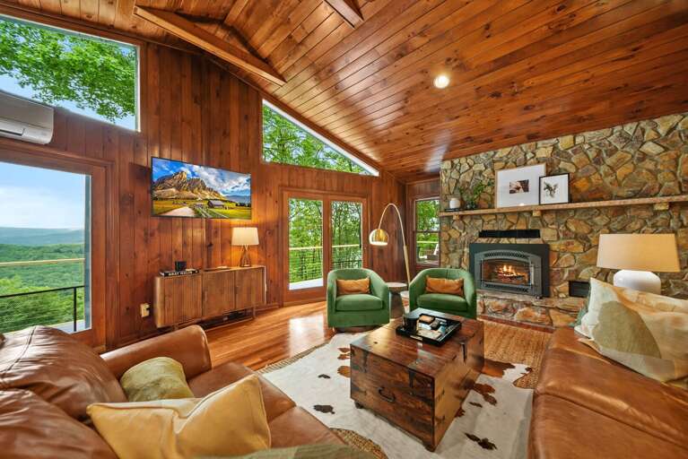 Main Living Area Features Large TV, Floor to Ceiling Stone Fireplace, and Deck Access Main Living Area Features Large TV, Floor to Ceiling Stone Fireplace, and Deck Access
