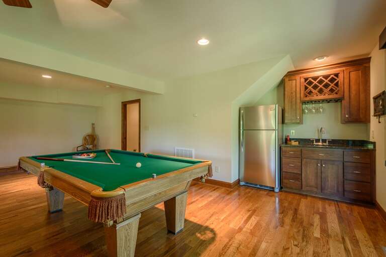 Lower Level Den Includes a Wet Bar and Second Full-Size Fridge by the Pool Table
