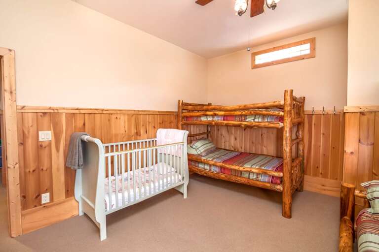 Downstairs bunk room with crib