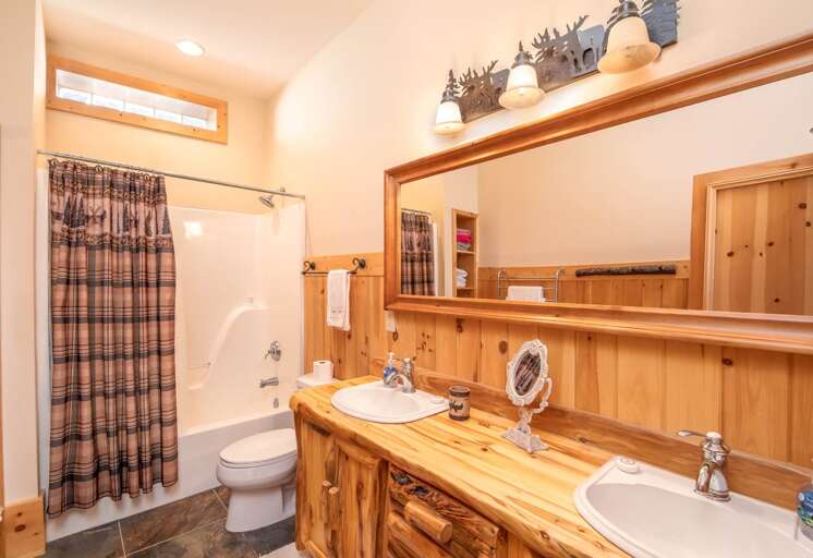 One of two downstairs full bathrooms, one with tub/shower combo, and one with shower and towel warmer