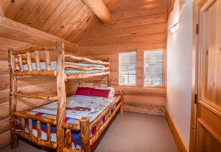 Upstairs bunk room in right wing, with twin over full log bunk bed
