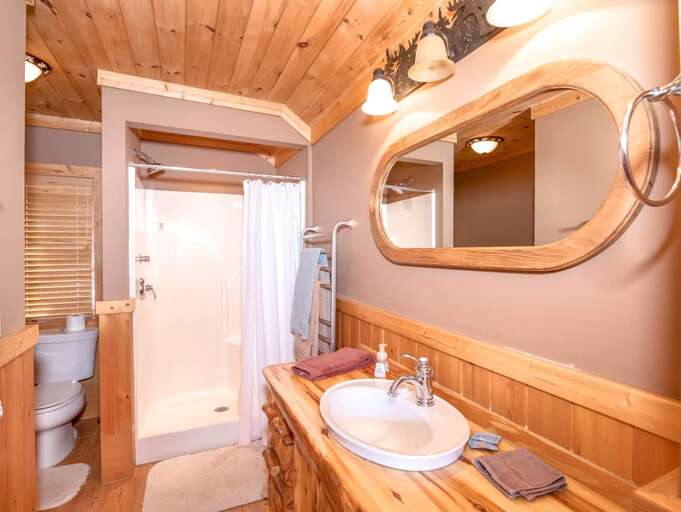 One of two upstairs full bathrooms, each with shower and towel warmer