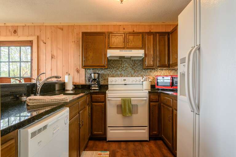 Kitchen on Main Level looks over Bar into Dining Area Kitchen on Main Level looks over Bar into Dining Area