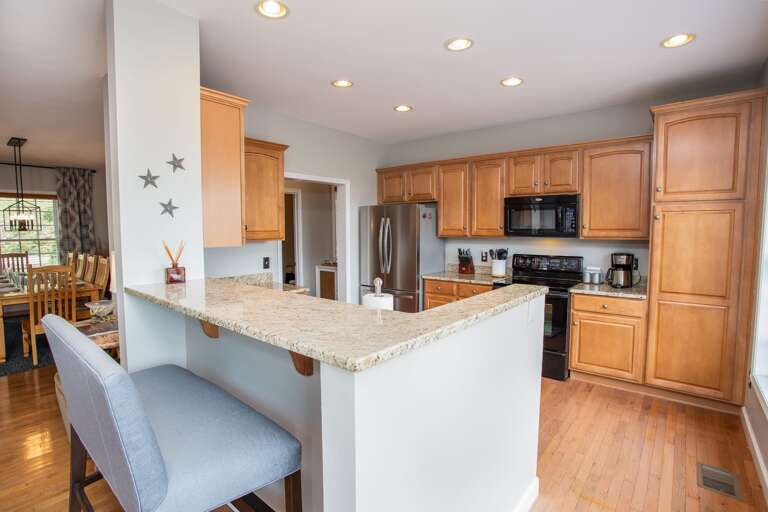 Kitchen with bar seating and open floor plan