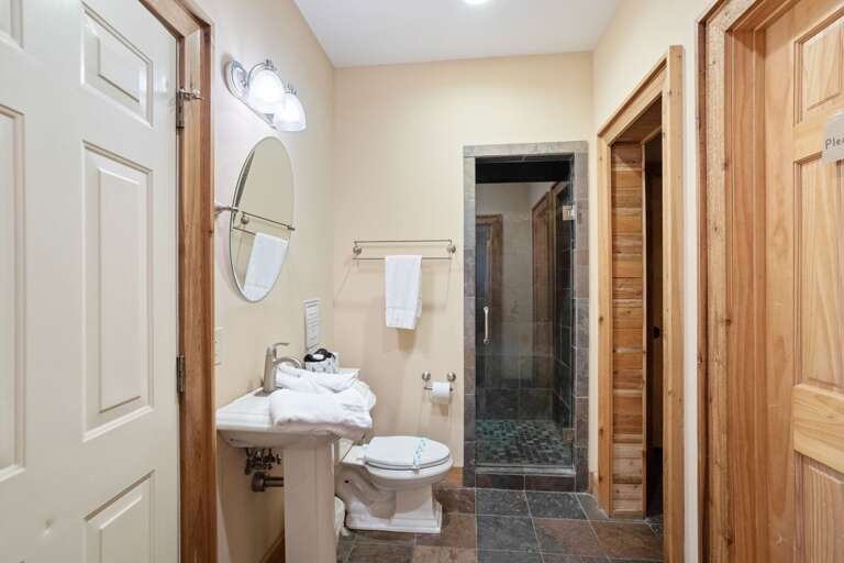 Full Bathroom and Large Tile Shower Outside of the Sauna Room