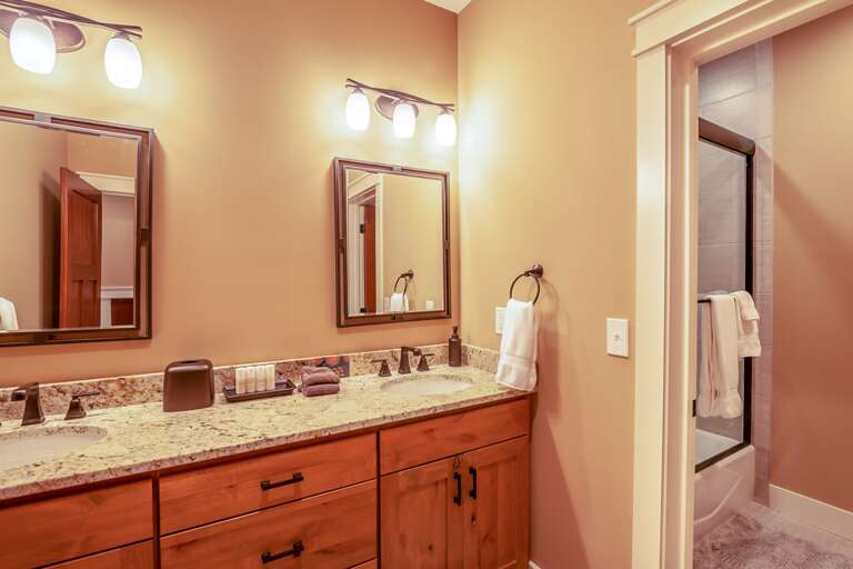 Lower Level Full Bathroom with Granite Vanity and Double Sinks Lower Level Full Bathroom with Granite Vanity and Double Sinks