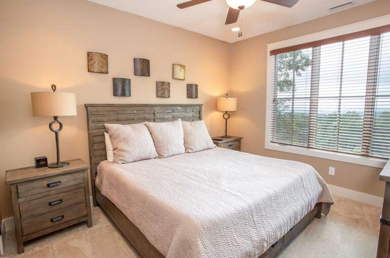 Lower Level King Bedroom with Large Bay Window Looking Out at Mountain Views Lower Level King Bedroom with Large Bay Window Looking Out at Mountain Views