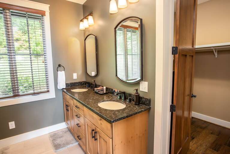 Main Level Master Bathroom has Granite Vanity with Double Sinks and Large Tiled Shower with Frameless Glass Door Main Level Master Bathroom has Granite Vanity with Double Sinks and Large Tiled Shower with Frameless Glass Door