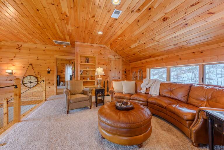 Cozy Loft with Carpeted Flooring and Leather Furniture