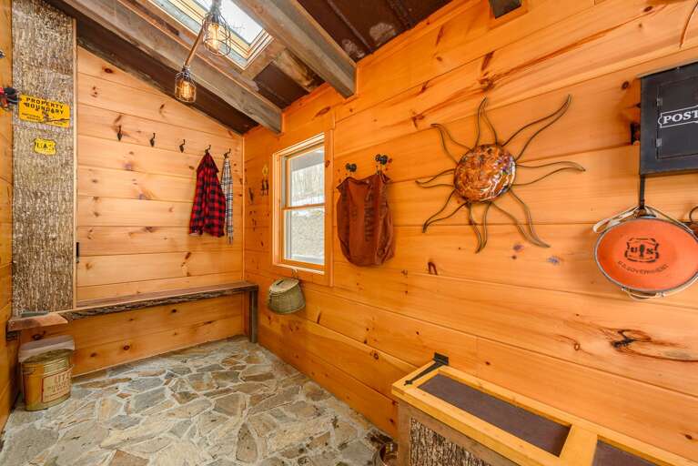 Main Entry Mud Room with Stone Floors and Skylights, Built-in Bench and Wood Walls