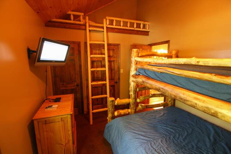TV in main floor bunk room with loft sleeping nook for 1